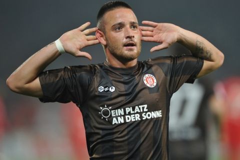of Berlin is challenged by of St. Pauli during the Second Bundesliga match between 1. FC Union Berlin and FC St. Pauli at Stadion An der Alten Foersterei on October 28, 2011 in Berlin, Germany.