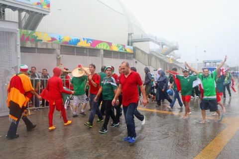 NATAL, BRAZIL - JUNE 13: Fans brave the rain before the 2014 FIFA World Cup Brazil Group A match between Mexico and Cameroon at Estadio das Dunas on June 13, 2014 in Natal, Brazil.  (Photo by Miguel Tovar/Getty Images)