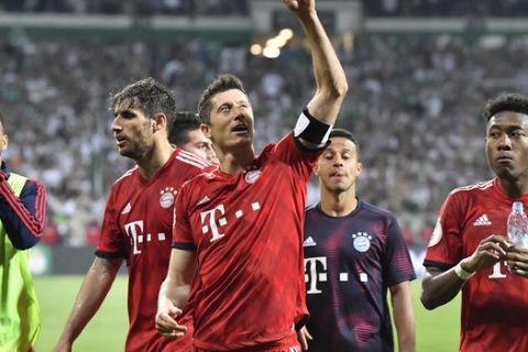 Bayern players with Robert Lewandowski pointing celebrate their 3-2 win after the German soccer cup, DFB Pokal, semifinal match between Werder Bremen and Bayern Munich at the Weser stadium in Bremen, Germany, Wednesday, April 24, 2019. (AP Photo/Martin Meissner)