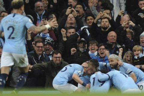 Manchester City players celebrate after Vincent Kompany scored his side's opening goal during the English Premier League soccer match between Manchester City and Leicester City at the Etihad stadium in Manchester, England, Monday, May 6, 2019. (AP Photo/Rui Vieira)