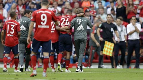Bayern's Corentin Tolisso leaves the field injured during the German Bundesliga soccer match between FC Bayern Munich and Bayer Leverkusen in Munich, Germany, Saturday, Sept. 15, 2018. (AP Photo/Matthias Schrader)