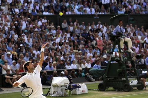 Serbia's Novak Djokovic serves to Switzerland's Roger Federer during the men's singles final match of the Wimbledon Tennis Championships in London, Sunday, July 14, 2019. (AP Photo/Ben Curtis)