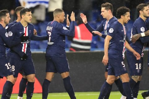 PSG's Kylian Mbappe, centre, celebrates with PSG's Julian Draxler, centre right, after scoring his side's second goal during the French League One soccer match between Paris-Saint-Germain and Dijon, at the Parc des Princes stadium in Paris, France, Saturday, Feb. 29, 2020. (AP Photo/Michel Euler)