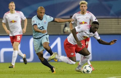 Porto's Yacine Brahimi, left, battles for the ball with Leipzig's Jean-Kevin Augustin, right, during the Champions League Group G first leg soccer match between RB Leipzig and FC Porto in Leipzig, Germany, Tuesday, Oct. 17, 2017. (AP Photo/Jens Meyer)