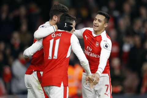Arsenal's Olivier Giroud, from left, Arsenal's Mesut Ozil and Arsenal's Alexis Sanchez celebrate after scoring during the English Premier League soccer match between Arsenal and Bournemouth at Emirates stadium in London, Sunday, Nov. 27, 2016.(AP Photo/Frank Augstein)