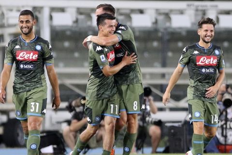 Napoli's Hirving Lozano, center, celebrates with teammates, from left, Faouzi Ghoulam, Fabian Ruiz and Dries Mertens after scoring his side's 2nd goal during the Serie A soccer match between Hellas Verona and Napoli at the Marcantonio Bentegodi Stadium in Verona, Italy, Tuesday, June 23, 2020. (Paola Garbuio/LaPresse via AP)
