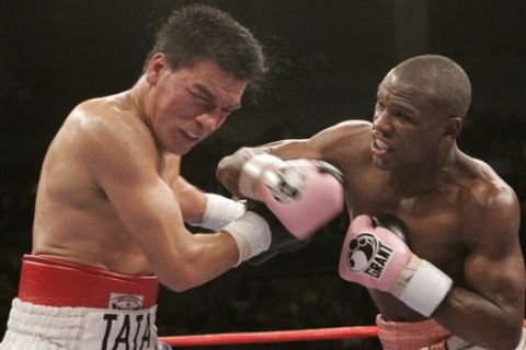 Floyd Mayweather Jr., right, connects with a punch to the jaw of Carlos Baldomir, of Argentina, during the sixth round of their WBC Welterweight Championship boxing match, Saturday Nov. 4, 2006, at The Mandalay Bay Resort & Casino in Las Vegas. (AP Photo/Eric Jamison)