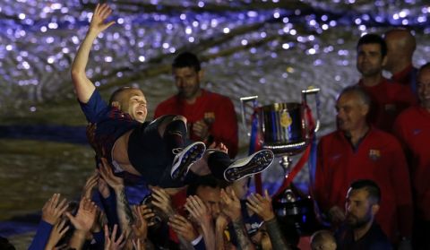 FC Barcelona's Andres Iniesta is tossed by his teammates after the Spanish La Liga soccer match between FC Barcelona and Real Sociedad at the Camp Nou stadium in Barcelona, Spain, Sunday, May 20, 2018. Iniesta announced last month he would leave Barcelona after 16 seasons. (AP Photo/Manu Fernandez)