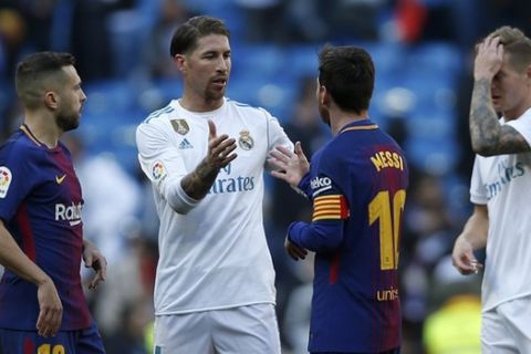 Real Madrid's Sergio Ramos, center left, shakes hands with Barcelona's Lionel Messi at the end of the Spanish La Liga soccer match between Real Madrid and Barcelona at the Santiago Bernabeu stadium in Madrid, Spain, Saturday, Dec. 23, 2017. Barcelona won 3-0. (AP Photo/Francisco Seco)