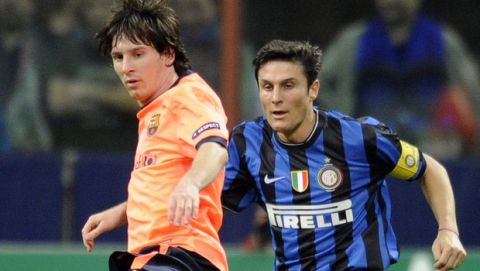 Barcelona's Lionel Messi stops the ball as Inter Milan captain Javier Zanetti of Argentina looks on during a Champions League semifinal first leg soccer match between Inter Milan and Barcelona at the San Siro stadium in Milan, Italy,Tuesday, April 20, 2010. (AP Photo/str)