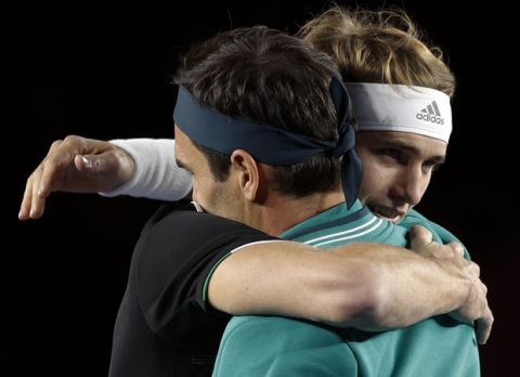 Germany's Alexander Zverev, left, embraces Roger Federer of Switzerland at the start of their exhibition tennis match at Plaza de Toros bullring in Mexico City, Saturday, Nov. 23, 2019. Saturday's match was the fourth stop in a tour of Latin America by the tennis greats. (AP Photo/Rebecca Blackwell)