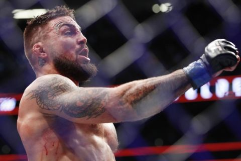 Mike Perry celebrates after defeating Paul Felder in a welterweight mixed martial arts bout at UFC 226, Saturday, July 7, 2018, in Las Vegas. (AP Photo/John Locher)
