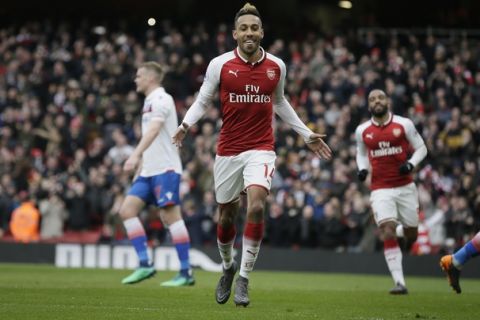 Arsenal's Pierre-Emerick Aubameyang celebrates after scoring a penalty during the English Premier League soccer match between Arsenal and Stoke City at the Emirates Stadium in London, Sunday, April 1, 2018. (AP Photo/Tim Ireland)
