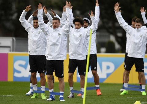 Germany's forward Lukas Podolski, front, exercises with the national team prior the friendly soccer match between Germany and England in Dortmund, Germany, Tuesday, March 21, 2017.  Germany play a friendly soccer match against England on Wednesday. (AP Photo/Martin Meissner)