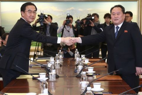 South Korean Unification Minister Cho Myoung-gyon, left, poses with head of North Korean delegation Ri Son Gwon while shaking hands during their meeting at the Panmunjom in the Demilitarized Zone in Paju, South Korea, Tuesday, Jan. 9, 2018. Senior officials from the rival Koreas said Tuesday they would try to achieve a breakthrough in their long-strained ties as they sat for rare talks at the border to discuss how to cooperate in next month's Winter Olympics in the South and other issues. (Korea Pool via AP)