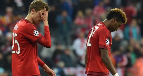 "Bayern Munich's midfielder Thomas Mueller (L) and Bayern Munich's French defender Kingsley Coman  leave the pitch after the UEFA Champions League semi-final, second-leg football match between FC Bayern Munich and Atletico Madrid in Munich, southern Germany, on May 3, 2016. / AFP / Christof Stache        (Photo credit should read CHRISTOF STACHE/AFP/Getty Images)"