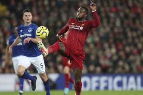 Liverpool's Divock Origi scores his second goal against Everton during the English Premier League soccer match between Liverpool and Everton at Anfield Stadium, Liverpool, England, Wednesday, Dec. 4, 2019. (AP Photo/Jon Super)