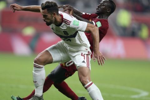 Flamengo's Pablo Mari, front, vies for the ball with Liverpool's Sadio Mane during the Club World Cup final soccer match between Liverpool and Flamengo at Khalifa International Stadium in Doha, Qatar, Saturday, Dec. 21, 2019. (AP Photo/Hussein Sayed)