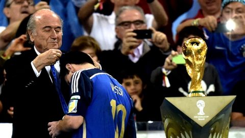 Argentina's Lionel Messi gets his runners-up medal from FIFA President Sepp Blatter after the World Cup final soccer match between Germany and Argentina at the Maracana Stadium in Rio de Janeiro, Brazil, Sunday, July 13, 2014. Germany won the match 1-0. (AP Photo/Martin Meissner)