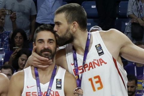 Spain's Marc Gasol, center right, kisses Spain's Juan Carlos Navarro, center left, after defeating Russia during their Eurobasket European Basketball Championship bronze medal match in Istanbul, Sunday, Sept. 17. 2017. (AP Photo/Thanassis Stavrakis)