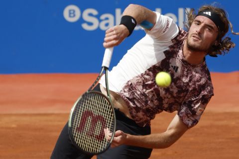 Stefanos Tsitsipas, of Greece, returns the ball to Lorenzo Musetti, of Italy, during a semi final open tennis tournament, in Barcelona, Spain, Saturday, April 22, 2023. (AP Photo/Joan Monfort)