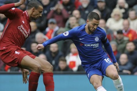 Chelsea's Eden Hazard, right, duels for the ball with Liverpool's Joel Matip during the English Premier League soccer match between Liverpool and Chelsea at Anfield stadium in Liverpool, England, Sunday, April 14, 2019. (AP Photo/Rui Vieira)