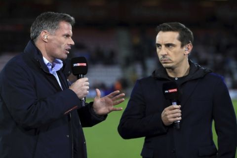 FILE - In this file photo dated Sept. 15, 2017, Sky Sports commentators Jamie Carragher, left, and Gary Neville, at Bournemouth, England.  Former Liverpool defender Jamie Carragher was suspended as a soccer analyst by the Sky television network on Monday March 12, 2018, after being filmed spitting in the direction of a 14-year-old girl through his car window. (John Walton/PA via AP)