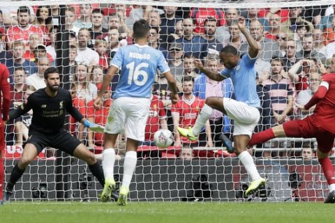Manchester City's Raheem Sterling, second from right, scores his side's opening goal during the English Community Shield soccer match between Liverpool and Manchester City at Wembley stadium in London, Sunday, Aug. 4, 2019. (AP Photo/Kirsty Wigglesworth)