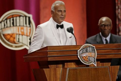 Nick Galis speaks during his enshrinement into the Naismith Memorial Basketball Hall of Fame as Bob McAdoo listens, Friday, Sept. 8, 2017, in Springfield, Mass. Galis won a European Championship gold medal and European Championships MVP in 1987 and was named as one of FIBA's 50 Greatest Players in 1991. (AP Photo/Stephan Savoia)