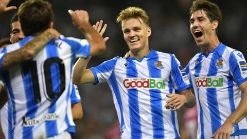 Real Sociedad's Martin Odegaard, center, celebrates after a goal of his team during the Spanish La Liga soccer match between Real Sociedad and Alaves at Reale Arena stadium, in San Sebastian, northern Spain, Thursday, Sept. 26, 2019. (AP Photo/Alvaro Barrientos)