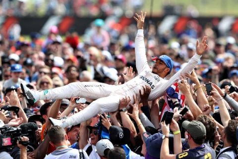 NORTHAMPTON, ENGLAND - JULY 10:  Lewis Hamilton of Great Britain and Mercedes GP celebrates his win by crowdsurfing with the fans during the Formula One Grand Prix of Great Britain at Silverstone on July 10, 2016 in Northampton, England.  (Photo by Mark Thompson/Getty Images)