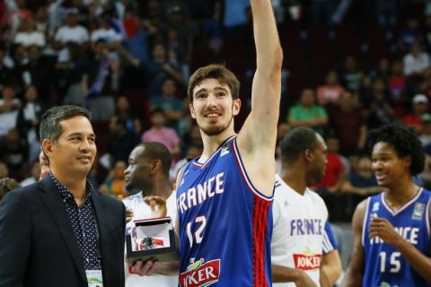 Nando de Colo of France waves to the crowd shortly after being voted the Most Valuable Player in the just-concluded FIBA Olympic Qualifying basketball match Sunday, July 10, 2016 at the Mall of Asia Arena in suburban Pasay city south of Manila, Philippines. Presenting the award is Al Panlilio, left. (AP Photo/Bullit Marquez)