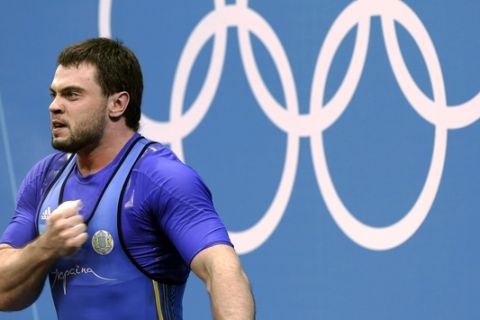 Oleksiy Torokhtiy of Ukraine reacts during men's 105-kg, group A, weightlifting competition at the 2012 Summer Olympics, Monday, Aug. 6, 2012, in London. (AP Photo/Hassan Ammar)