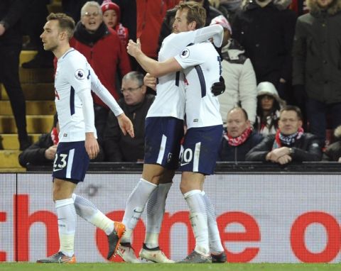 Tottenham's Harry Kane, right, celebrates after scoring his side's second goal during the English Premier League soccer match between Liverpool and Tottenham Hotspur at Anfield, Liverpool, England, Sunday, Feb. 4, 2018. (AP Photo/Rui Vieira)