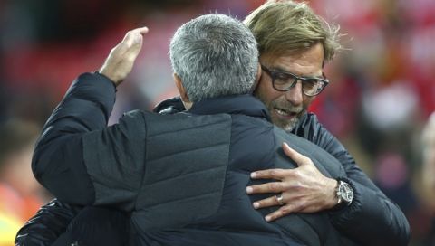 Liverpool's manager Juergen Klopp, right, hugs Manchester United's manager Jose Mourinho ahead of the English Premier League soccer match between Liverpool and Manchester United at Anfield stadium in Liverpool, England, Monday, Oct. 17, 2016. (AP Photo/Dave Thompson)