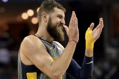 Memphis Grizzlies center Jonas Valanciunas applauds during the second half of the team's NBA basketball game against the Houston Rockets Wednesday, March 20, 2019, in Memphis, Tenn. The Grizzlies won 126-125 in overtime. (AP Photo/Brandon Dill)