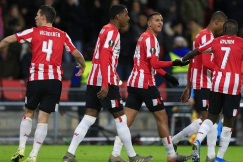 PSV players celebrate with PSV's Mohammed Ihattaren, third from right, after he scored his side's first goal during the group D Europa League soccer match between PSV and Rosenborg at the Philips stadium in Eindhoven, Netherlands, Thursday, Dec. 12, 2019. (AP Photo/Peter Dejong)