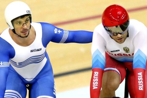 Christos Volikakis of Greece, left, embraces Denis Dimitriev of Russia, right, after their men's keirin cycling repechages at the Rio Olympic Velodrome during the 2016 Summer Olympics in Rio de Janeiro, Brazil, Tuesday, Aug. 16, 2016. (AP Photo/Pavel Golovkin)
