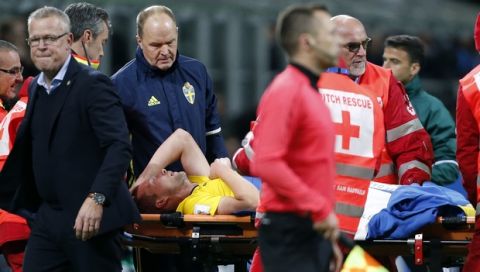 Sweden's Jakob Johansson is carried off the pitch on a stretcher during the World Cup qualifying play-off second leg soccer match between Italy and Sweden, at the Milan San Siro stadium, Italy, Monday, Nov. 13, 2017. (AP Photo/Antonio Calanni)