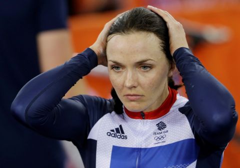 Britain's Victoria Pendleton holds her head after her and teammate Jessica Varnish and saw their medal hopes vanish when they were relegated for making an early change in the first round of a track cycling women's team sprint  event, during the 2012 Summer Olympics, Thursday, Aug. 2, 2012, in London. (AP Photo/Matt Rourke)