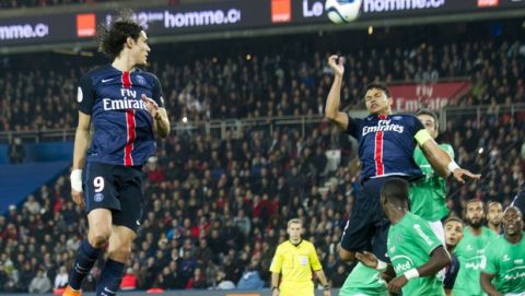 PSG's Edinson Cavani, left, with Thiago Silva, center, challenge for the ball against Saint Etienne during their French League One soccer match, Sunday Oct. 25 2015, in Parc des princes stadium, in Paris, France. (AP Photo/Jacques Brinon)