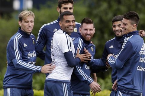 Argentina's Lionel Messi, center, shares a light moment with teammates as they train for a 2018 Russia World Cup qualifying soccer match against Peru in Buenos Aires, Argentina, Tuesday, Oct. 3, 2017. (AP Photo/Victor R. Caivano)