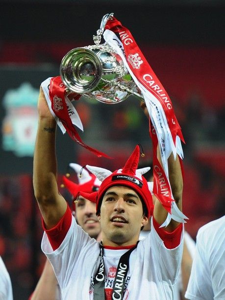 LONDON, ENGLAND - FEBRUARY 26:  Luis Suarez of Liverpool celebrates with the trophy after victory in the Carling Cup Final match between Liverpool and Cardiff City at Wembley Stadium on February 26, 2012 in London, England. Liverpool won 3-2 on penalties.  (Photo by Mike Hewitt/Getty Images)
