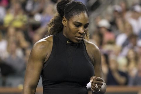 Serena Williams pumps her fist while playing opponent and sister Venus Williams during the third round of the BNP Paribas Open tennis tournament at the Indian Wells Tennis Garden in Indian Wells, Calif., Monday, March 12, 2018. (AP Photo/Crystal Chatham)