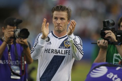 Los Angeles Galaxy's David Beckham, of England, acknowledges the fans as he leaves the field after the team's 3-1 win in the MLS Cup championship soccer match against the Houston Dynamo in Carson, Calif., Saturday, Dec. 1, 2012. (AP Photo/Jae C. Hong)