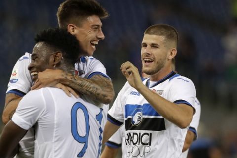 Atalanta's Emiliano Rigoni, center, is celebrated by teammates after scoring during a Serie A soccer match between Roma and Atalanta, in Rome's Olympic stadium, Monday, Aug. 27, 2018. (AP Photo/Andrew Medichini)