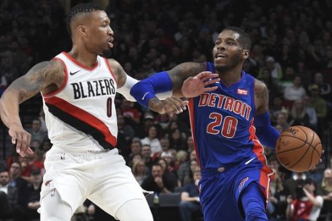 Detroit Pistons guard Dwight Buycks tries to get past Portland Trail Blazers guard Damian Lillard during the first half of an NBA basketball game in Portland, Ore., Saturday, March 17, 2018. (AP Photo/Steve Dykes)