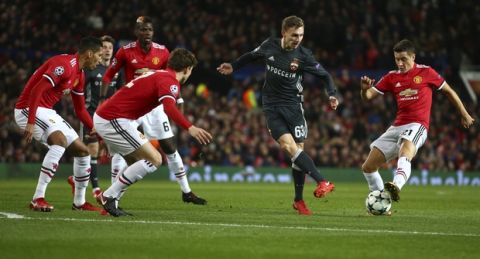 Manchester United's Ander Herrera, right, blocks the ball as CSKA's Fedor Chalov, center, passes during the Champions League group A soccer match between Manchester United and CSKA Moscow in Manchester, England, Tuesday, Dec. 5, 2017. (AP Photo/Dave Thompson)