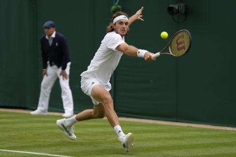 Stefanos Tsitsipas of Greece returns to Austria's Dominic Thiem in a first round men's singles match on day two of the Wimbledon tennis championships in London, Tuesday, July 4, 2023. (AP Photo/Alastair Grant)