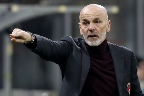 AC Milan's manager Stefano Pioli gives instructions to his players during an Italian Cup soccer match between AC Milan and Juventus at the San Siro stadium, in Milan, Italy, Thursday, Feb. 13, 2020. (AP Photo/Antonio Calanni)